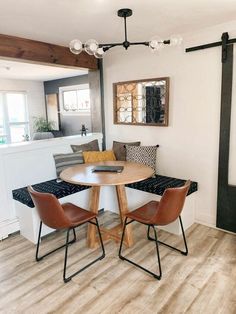 a kitchen table with four chairs around it