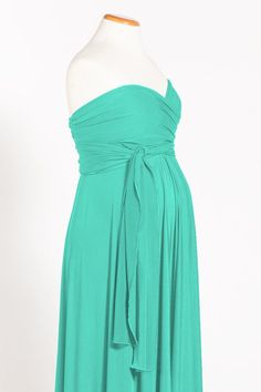 a woman in a green dress on a mannequin