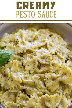 creamy pesto sauce in a white bowl with basil leaves on top and text overlay