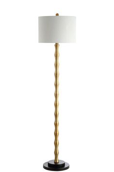 a gold lamp with a white shade on the base and a black base is shown