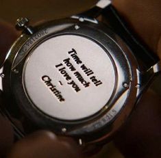 a person holding onto a watch with the words happy birthday written on it