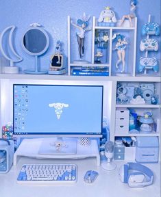 a desktop computer sitting on top of a desk next to a keyboard and mouse in front of a blue wall