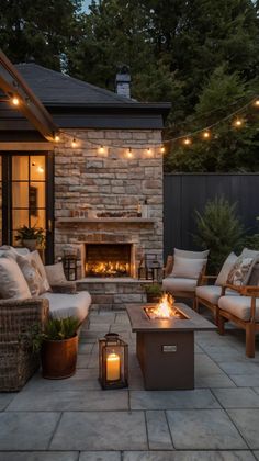 a fire pit surrounded by furniture and lights