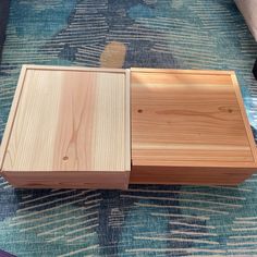 two wooden boxes sitting on top of a rug