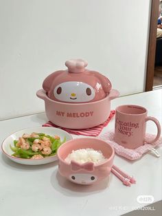 pink hello kitty dishes and cups on a white counter top with the words my melody printed on them