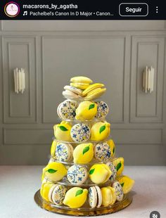 a cake made out of lemons and macarons on a plate with the words macaroons by, agathha