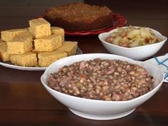 three bowls filled with food sitting on top of a wooden table next to a pie