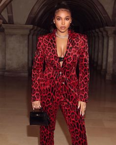 a woman in a red and black animal print suit