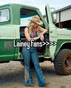 a woman standing next to a green truck with the words laney fans on it