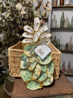 a wicker basket filled with oysters on top of a table next to a plant