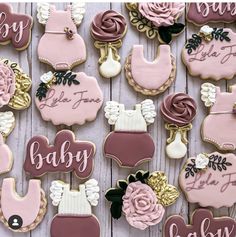 baby shower cookies decorated with pink and brown icing on a white wooden table top