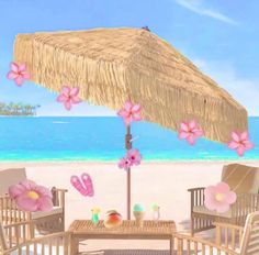 an umbrella and chairs on the beach with pink flowers in front of blue ocean water