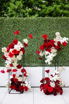 two vases filled with red and white flowers