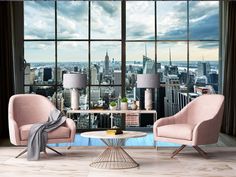 a living room with two chairs and a table in front of a large window overlooking the city