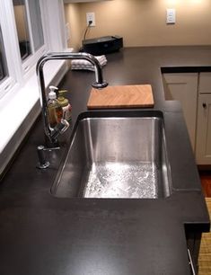 a kitchen with a sink and counter top