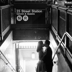 a man and woman kissing on the stairs in an underground subway station, new york city