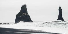 two large rocks sticking out of the ocean