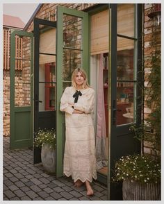 a woman standing in front of a green door