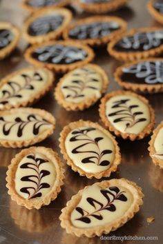 small desserts with chocolate and white icing on a table