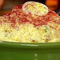 a green bowl filled with food on top of a table