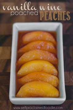 vanilla wine peaches in a white dish on a wooden table