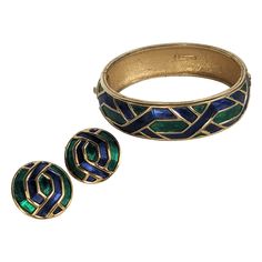 Marcel Boucher Enamel Bangle Suite from the 1960's. Bangle and matching ear clip earrings. Gilt metal with emerald and deep sapphire glowing enamel in geometric motifs. 1960's USA. Bracelet .65" wide. Earrings .75". Usa Bracelet, Enamel Bangle, Geometric Motifs, Clip Earrings, Clip On Earrings, Metallica, Bangle Bracelets, Jewelry Bracelets, Emerald