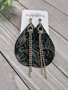 Gorgeous holiday leather earrings with all the sparkle from rhinestone chain and studs! The leather is black with dark green and gold floral pattern. I gladly accept returns & exchanges within 7 days. Please see my policies page for more details. Follow me on Instagram & Pinterest - @heartlander_ok Earrings Fancy, Pink Tassel Earrings, Unique Earring, Holiday Earrings, Rhinestone Chain, Pink Tassel, Holiday Earring, Mom And Sister, Gold Floral