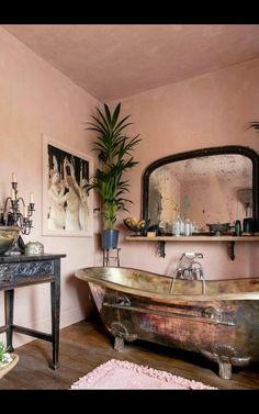 a bath tub sitting in the middle of a bathroom next to a sink and mirror