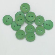 green buttons with yellow stitching on them