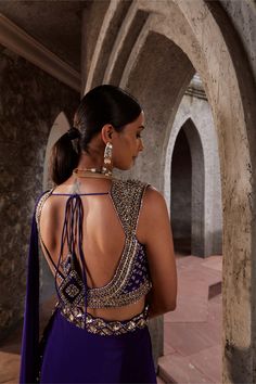 Elegance personified in a purple crepe sari paired with a fully embroidered sweetheart neck blouse in silk. The padded blouse, adorned with intricate embroidery, ensures a seamless fit with its side zip closure. The ensemble is perfected with an embellished belt, adding a touch of glamour to this sophisticated outfit. Purple Embroidered Blouse With Traditional Drape, Transitional Purple Saree With Cutdana Details, Luxury Purple Blouse With Cutdana Details, Embellished Purple Georgette Blouse Piece, Festive Purple Embroidered Pre-draped Saree, Modern Blouse Designs, Lehenga Top, Blouse Necklines, Fashion Show Dresses