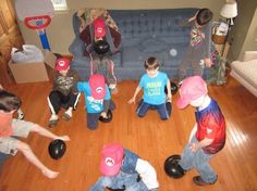 a group of young children standing around each other on top of a hard wood floor