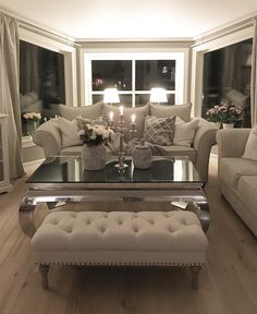 a living room filled with furniture and candles