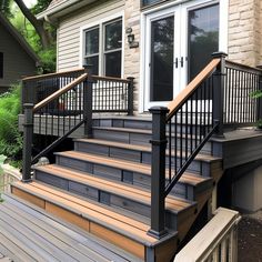 an outside view of a house with stairs and railings leading to the front door