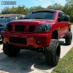 a red pick up truck parked on the side of a road