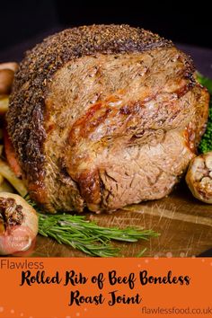 a large piece of meat sitting on top of a wooden cutting board next to some vegetables