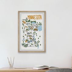 a framed minnesota map hangs above a desk