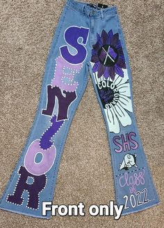 Custom made to order senior/hoco jeans. Walk in style showing your school spirit! I don't have finished jeans as this is a made to order item. See below for more info! JEANS WOULD NEED TO BE SHIPPED TO IN ORDER TO DO IT. Seniors Painted Jeans, Jean Pants Design, Senior Pants High Schools 2025, Purple Senior Jeans, Homecoming Jeans Ideas Sophomore, Senior Overalls Ideas High Schools 2025, Hoco Jeans Painted Ideas