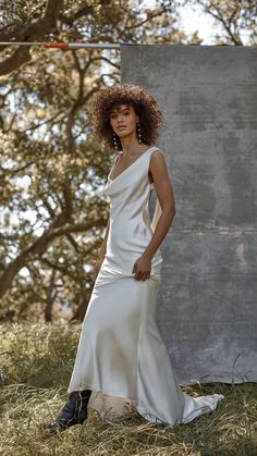 a woman in a white dress posing for a photo