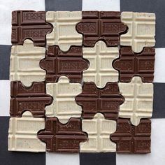 several pieces of chocolate sitting on top of a checkered table