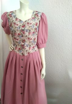 80s folk dress, puffy sleeve, floral dress, cottagecore dress, prairie peasant dress 12 US size button front dress austrian tyrolean dress, dusted pink color. have straps on the back to be adjustable. no label composition. GOOD VINTAGE CONDITION BUT THE ITEM IS NOT DRY CLEAN OR WASHED  measurements lying flat : shoulders :39 cm (15.5 inches) bust:51 cm (20 inches) waist :47 cm (18.5 inches) hips :free total length :120 cm (47 inches) sleeve length :38cm (15 inches) Peasant Style Fitted Puff Sleeve Dress, Fitted Peasant Dress With Puff Sleeves, Fitted Puff Sleeve Boho Dress, Cottagecore Fitted Vintage Dress With Buttons, Cottagecore Prairie Dress With Puff Sleeves, Fitted Cottagecore Prairie Dress, Prairie Fashion, Tapestry Dress, Prairie Dresses