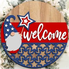 a welcome sign with a santa clause hat and stars in the center on a wooden plaque