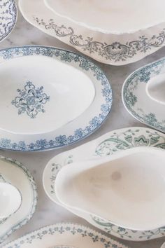 blue and white plates with designs on them are laid out in the middle of a table