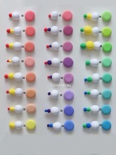 several different colored knobs are arranged on a white surface, including one for each button