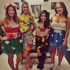 three women dressed in costumes posing for a photo with one woman standing next to the other