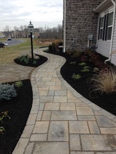 a brick walkway in front of a house