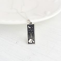 "Save 25% off your next purchase, sign up here: www.justjaynes.com/sign-up Sterling Silver Camping Necklace. This sterling silver rectangle camping charm necklace with trees and moon is layered with details that feel cozy and inviting. It'll get you dreaming of pitching a tent, exploring the woods, swimming in a mountain lake, and evenings spent roasting marshmallows. Wherever this camping charm takes you, it'll be the start of something good. Turn this charm into magical jewelry with broad appe Zelt Camping, Sterling Silver Charm Necklace, Wanderlust Jewelry, Mountain Necklace, Travel Keepsakes, Roasting Marshmallows, Hiking Gifts, Magical Jewelry, Starry Night Sky