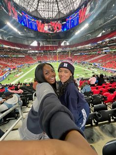 two women taking a selfie at a football game