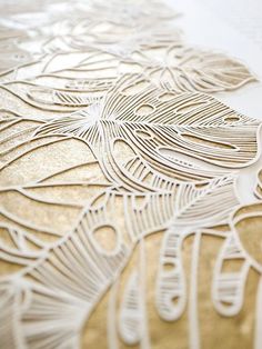 an intricately designed piece of paper with gold foil