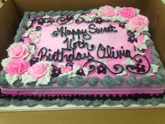 a birthday cake in a box with pink and gray frosting on it's side