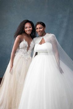 two women standing next to each other in wedding gowns and tulle skirted dresses